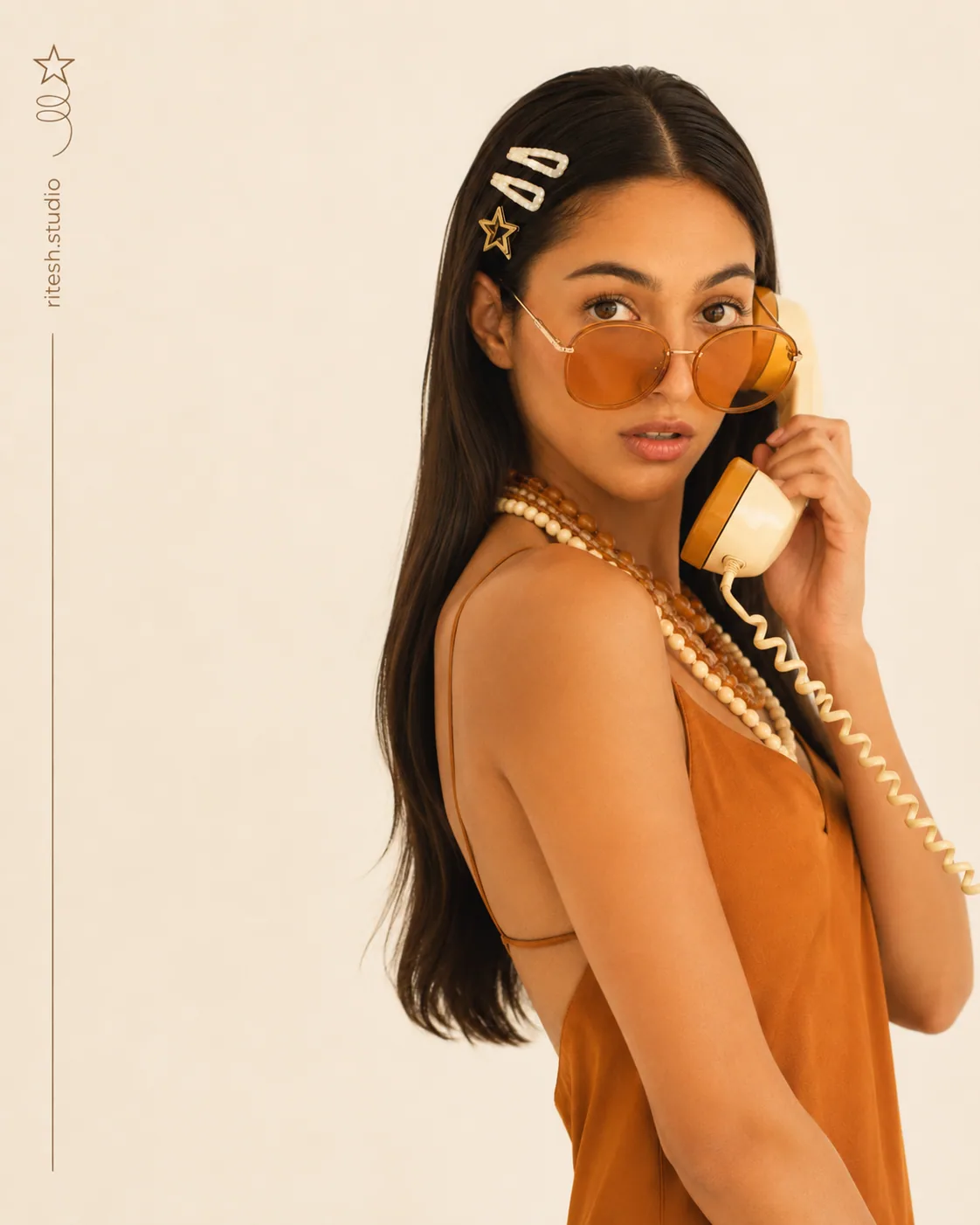 Woman holding a yellow telephone in an amber outfit