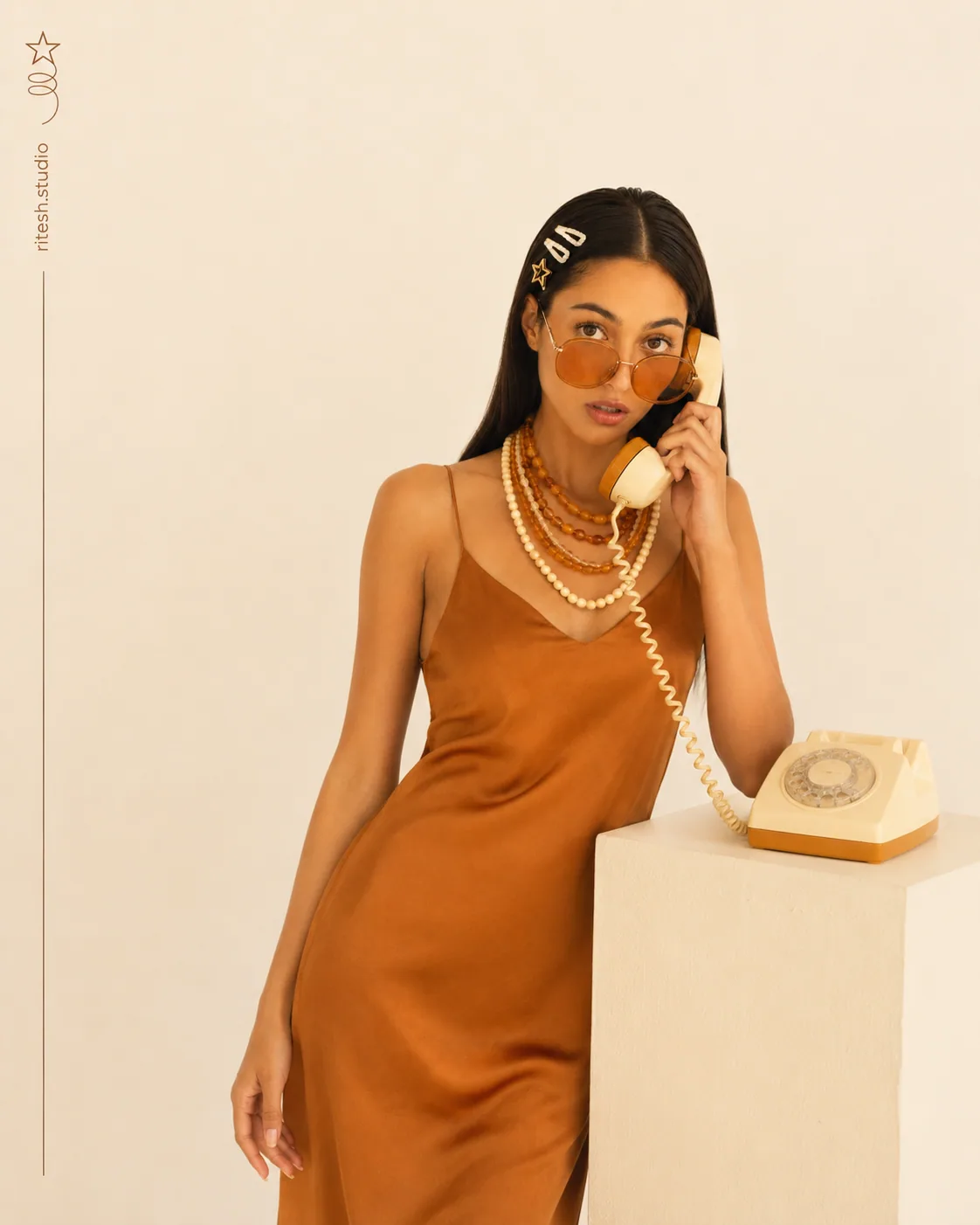 Seated fashion portrait with a yellow telephone